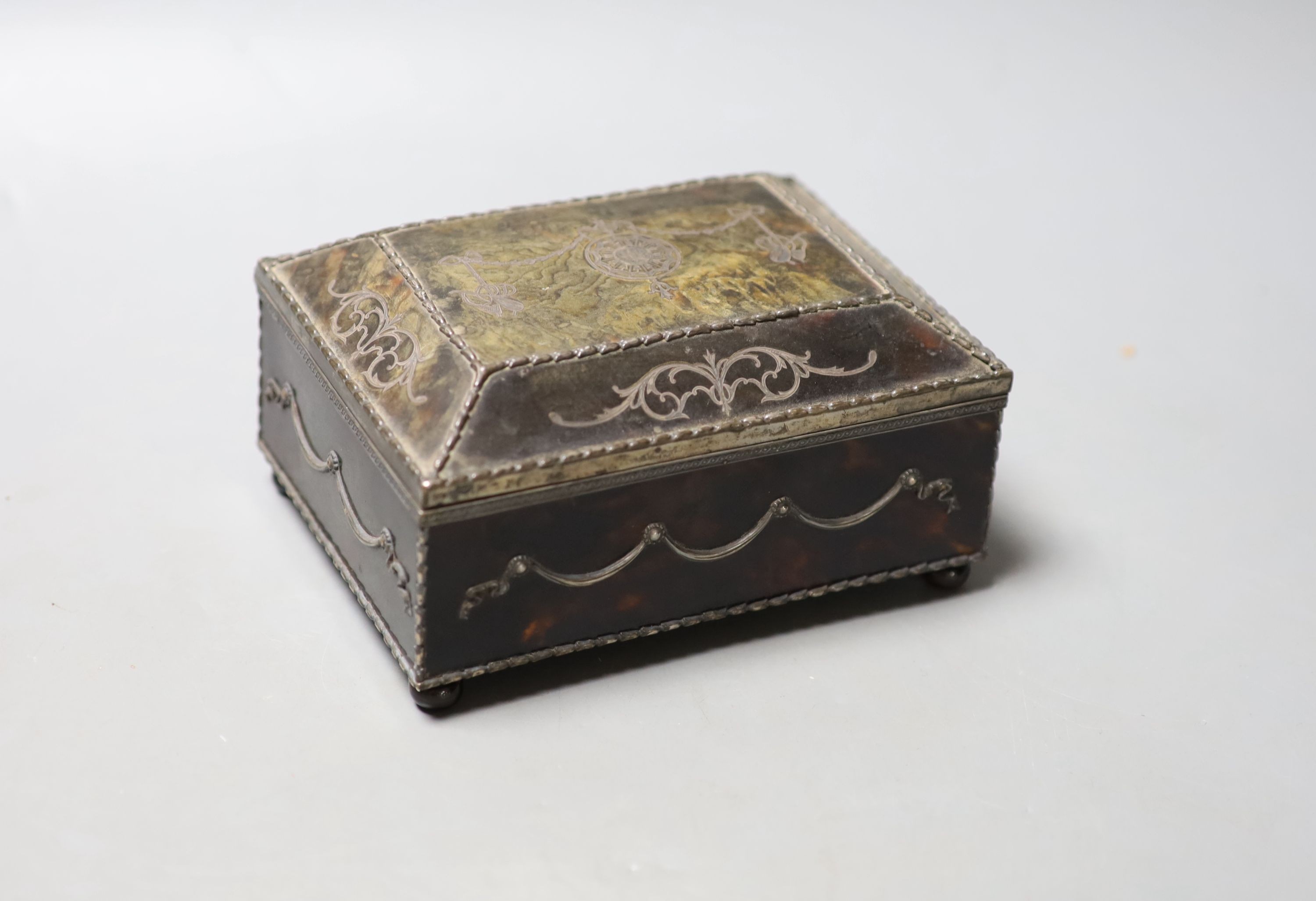 A silver-mounted tortoiseshell pique rectangular trinket box, by William Comyns, raised on four ball feet, London, 1904, width 15cm. 15cm